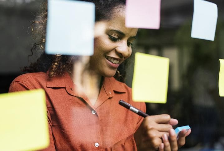 Woman writing on post-it notes